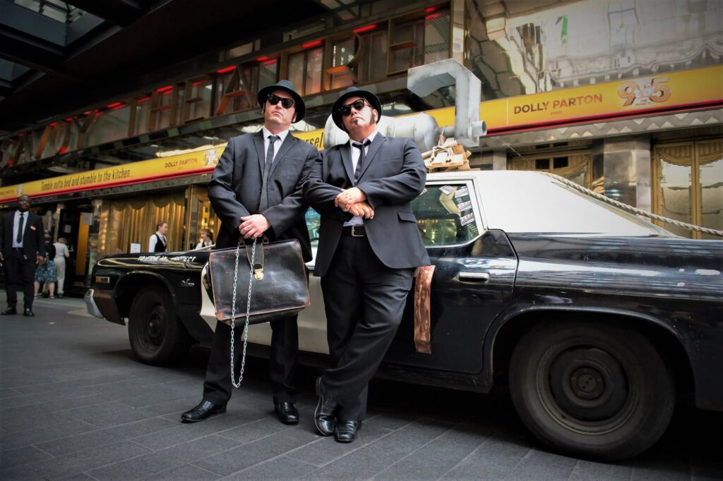 The Chicago Blues Brothers with the Bluesmobile outside the Savoy Theatre, London